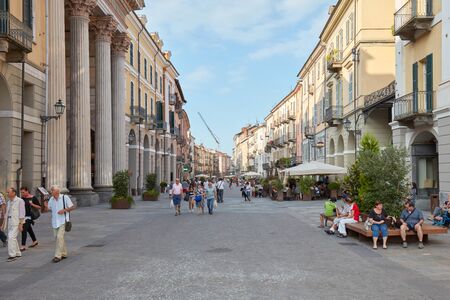 CUNEO, ITALY - AUGUST 13, 2015: Shopping street via Roma with people walking and historic buildings in a sunny summer day, blue sky in Cuneo, Italy.のeditorial素材
