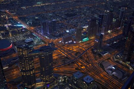 DUBAI, UNITED ARAB EMIRATES - NOVEMBER 19, 2019: Dubai illuminated city high angle view with skyscrapers and intricated streets at nightのeditorial素材
