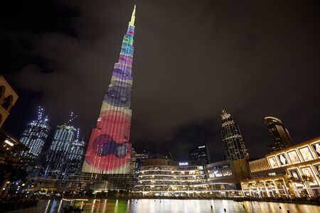 DUBAI, UNITED ARAB EMIRATES - NOVEMBER 21, 2019: Burj Khalifa skyscraper illuminated with colorful designs and Dubai Mall at nightのeditorial素材