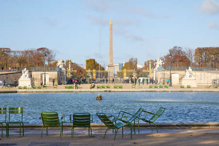 PARIS - NOVEMBER 7, 2019: Tuileries garden fountain and Place de la Concorde obelisk view with people, sunny autumn in Parisのeditorial素材