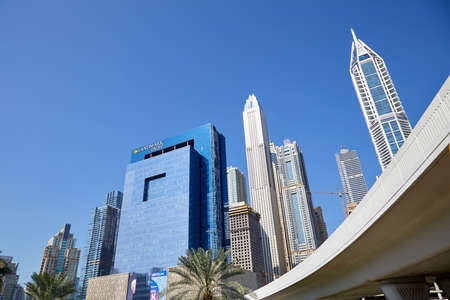 DUBAI, UNITED ARAB EMIRATES - NOVEMBER 22, 2019: Modern skyscrapers and flyover in Dubai downtown in a sunny day, clear blue skyのeditorial素材