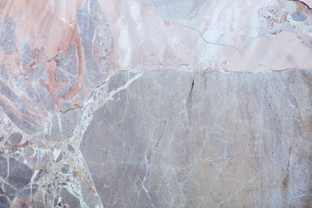 Grey, variegated stone texture background with cracksの写真素材