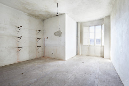 Empty, dirty room in old house, white wallsの写真素材