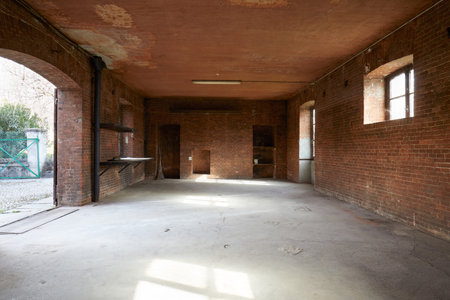 Old, empty workshop interior with brick wallsの写真素材