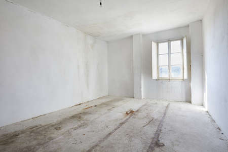 Empty, dirty room in old house, white wallsの写真素材