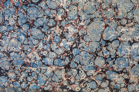 Old decorated paper with blue, red and black abstract faded design texture backgroundの写真素材