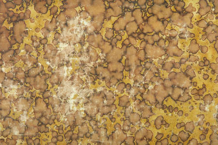 Old cardboard with yellow and brown faded abstract design texture backgroundの写真素材