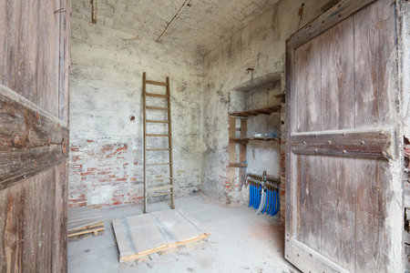 Old depository room with wooden portal in old country houseの写真素材