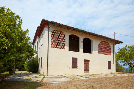Old country restored house with hayloft in a sunny day, blue sky in Italyの写真素材