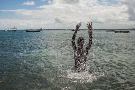 african woman splashing waterの写真素材
