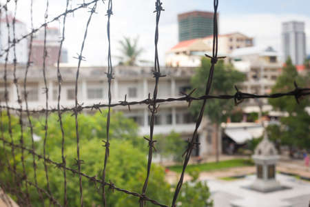 Barbed wire in memorial prison museum building in Cambodia close to Phnom Penh Pol Pot Holocaust