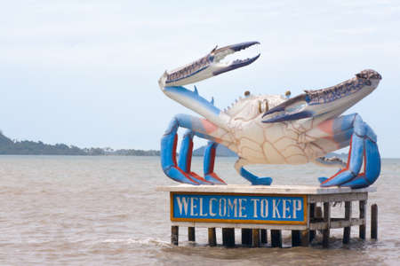Welcome to Kep Crab statue in Cambodia Sea Coast with blue claw chelaの写真素材