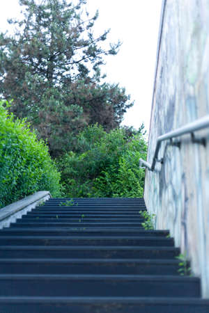 Concrete staircase of the underpass with Metal handrails and murals on wall In the suburbs italian...