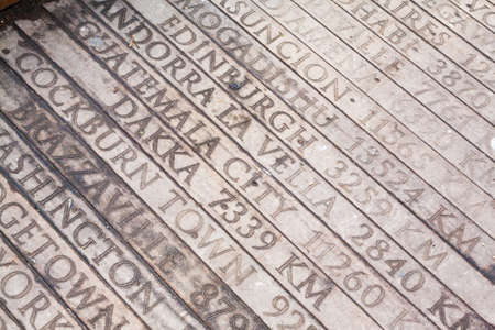 Wooden bridge with engraved geographical distances of world capitals from istanbul turkey to cockburn townの写真素材
