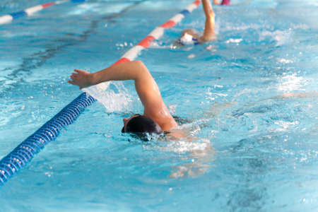 Swimming Kids Lesson red tshirt coach close to poolsideの写真素材