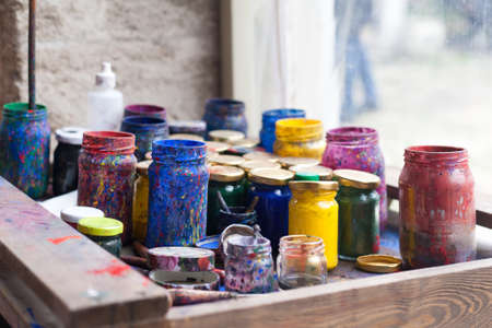 Color jars and tempera on working table in ceramic lab in turkeyの写真素材