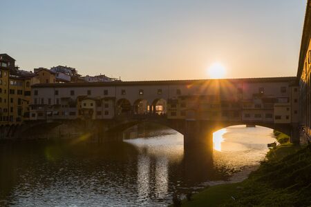 sunset on ponte vecchio, florence, italyの写真素材