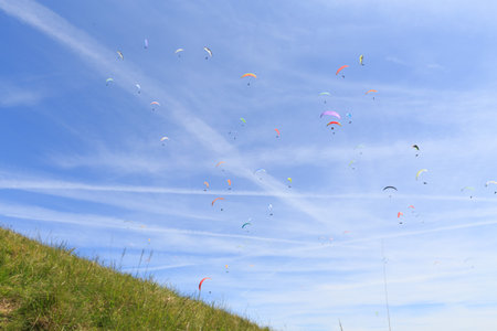 many paragliders in the skyの写真素材
