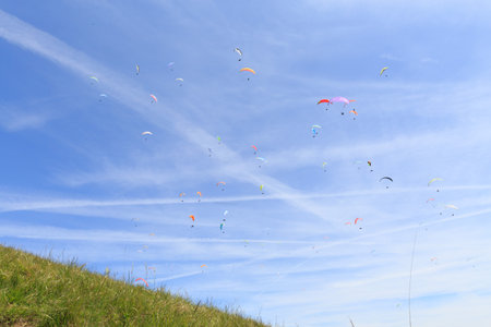 many paragliders in the skyの写真素材