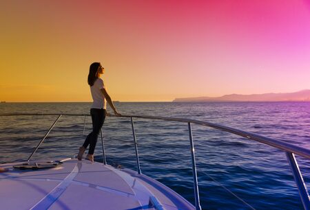 happy woman on the yacht, on the prow of luxury yacht