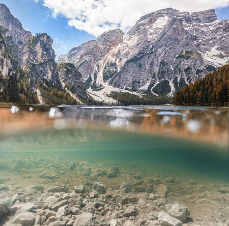 Braies Lake in Dolomites mountains forest trail in background, Sudtirol, Italy. Lake Braies is also...