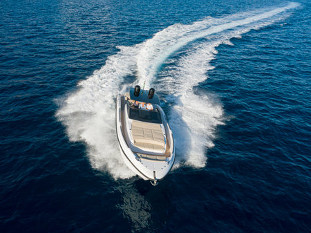Aerial view of a speedboat in the sea with white wakeの写真素材