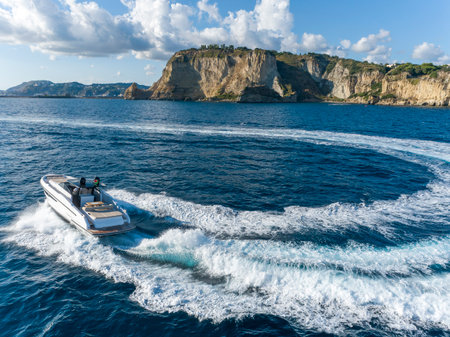 Motor boat in the sea on the background of the island of Capri, Italyの写真素材