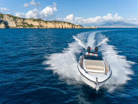 Motor boat in the sea on the background of the mountains and blue skyの写真素材
