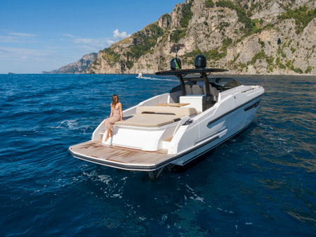 Young woman on a boat on the Amalfi coast, Italyの写真素材