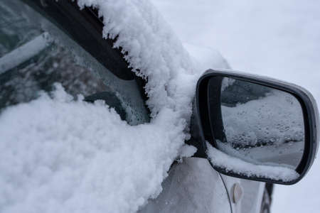 car fragment with side mirror in the snowの写真素材