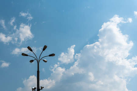 Modern street lamp against the blue sky and clouds. Space for lettering or design.の写真素材