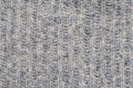 Close-up of a fragment of knitted woolen clothes. Space for lettering or design.