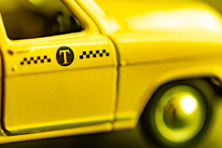Closeup of a taxi sign on the door of a yellow car. Soft focus. Selective focusの写真素材