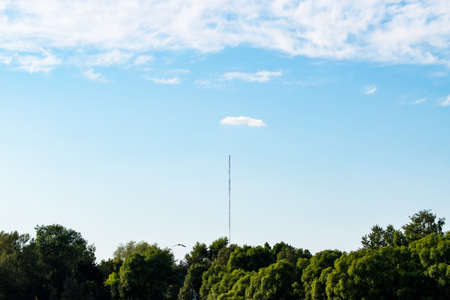 Abstract landscape, blue sky, clouds, forest and communication towerの写真素材