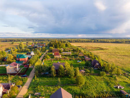 Suburban summer landscape with a birds eye view. Horizon line with fluffy clouds.の写真素材