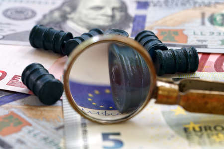Defocused image photographs view through a magnifying glass on oil barrels and banknotesの写真素材