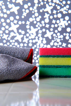 Stack of different colored sponges for washing and a rag for cleaning. Close-up. Selective focus