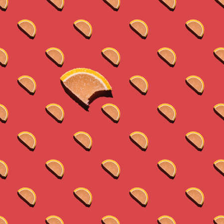Seamless pattern from a photo of slices of marmalade on a pink background. Wallpaper with sweets....