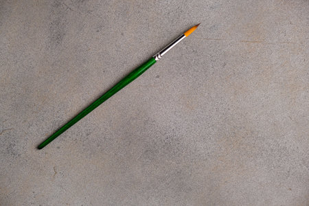 Synthetic brush for painting on an abstract gray background. Space for lettering and designの写真素材