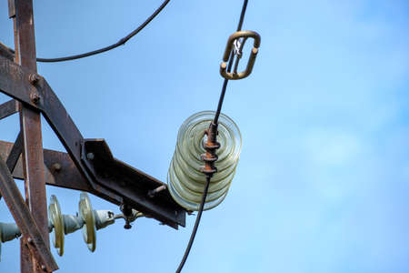 Fragment of an old high-voltage tower against the sky. Close-up. Selective focus.の写真素材