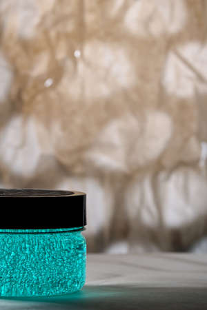 Close-up of a jar of cosmetics on an abstract background. Turquoise gel. Selective focus. copy spaceの写真素材