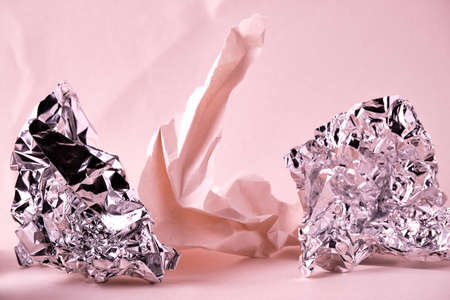 Abstract pink background with crumpled paper and foil elements. Selective focus. Backing for lettering, design and other creative purposesの写真素材