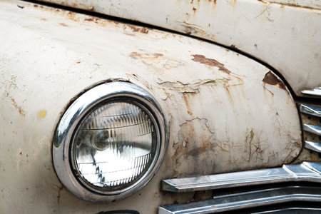 Fragment of an old rusty beige car. Fender and headlight. selective focus.の写真素材