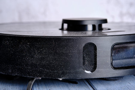 Fragment of an old dusty robot vacuum cleaner. close-up. selective focus.の写真素材