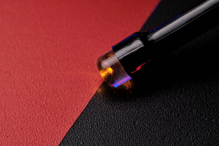 Close-up of an LED light bulb on a red-black background. selective focus.の写真素材