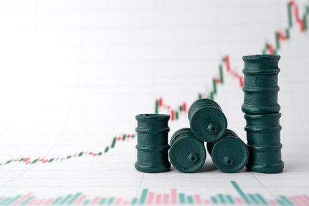 Miniature barrels and graphs of stock fluctuations. selective focus. close-up. The concept of rise and fall in the value of oil products and company shares.の写真素材
