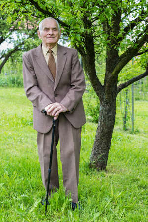 Handsome 80 plus year old senior man posing for a portrait in his garden  の写真素材