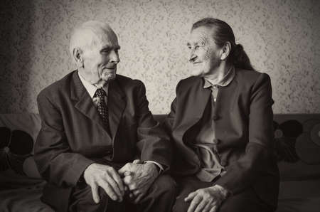 Cute 80 plus year old married couple posing for a portrait in their house  Love forever concept  の写真素材