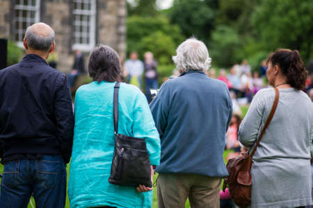 Older generation, seniors, enjoying an outdoors music, culture, community event, festival の写真素材