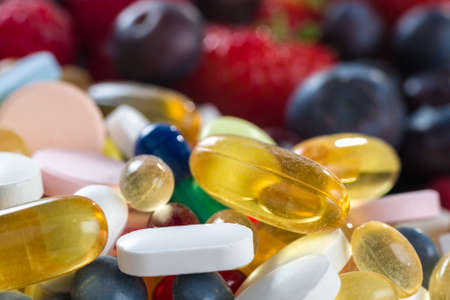 Healthy lifestyle, diet concept, Fruit and pills, vitamin supplements with on white backgroundの写真素材